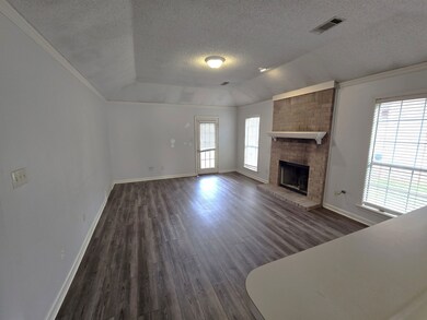Unfurnished living room featuring a fireplace, a t