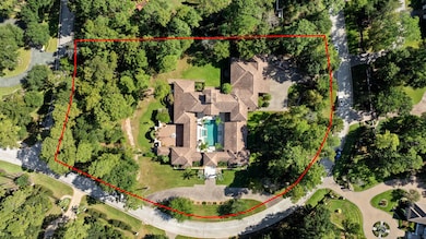 This well thought estate rests on an oversized corner lot in the tranquil gated community of Cochran's Crossing. A second back drive leads to additional parking and a 4 bay garage!