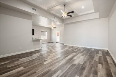 Spare room featuring a ceiling fan, coffered ceili