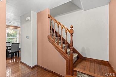 The entryway boasts even more hardwood flooring.  Positive feature is the half bath located just around the corner.