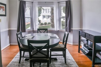 Hardwood floors in the Dining Room with a bay wind
