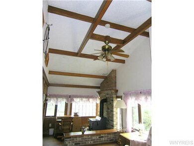 Foyer Hand hewn beams looking over to step down de