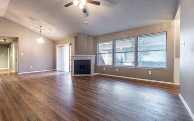 Unfurnished living room featuring a textured ceil