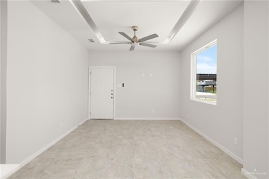 Unfurnished room featuring ceiling fan and light tile patterned floors