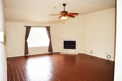 Large Living room with gas fireplace and tile flooring throughout common areas.