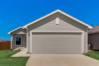Ranch-style house featuring concrete driveway and an attached garage