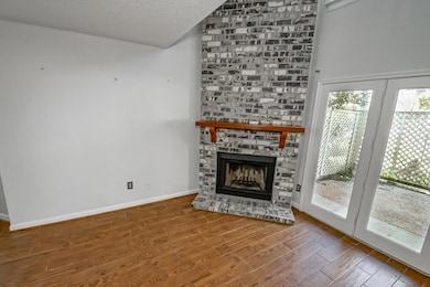 Living room fireplace and doors to patio