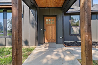 What a beautiful entrance to your home with stained beadboard matching the columns, front door and window corbels