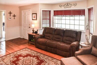 The living room features a bayed window, recessed 