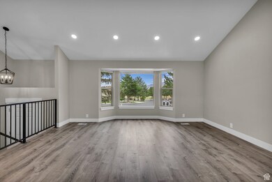 Unfurnished living room with recessed lighting, light wood-type flooring, and a chandelier