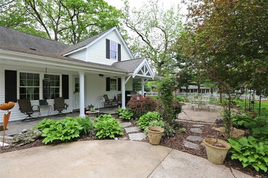 Back view of the home w/large porch
