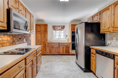Alternate view of kitchen.  Rear wall is lined with tons of cabinets, plus counter top space.  Also, note the double ovens, cook top, built-in microwave, dishwasher, and large fridge, which remains!  This is a well functioning kitchen!