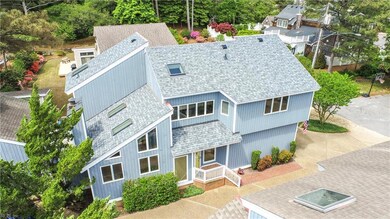 Stunning architectural design with walls of windows and new architectural shingled roof.