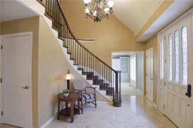 Stunning entry with sweeping staircase, marble til