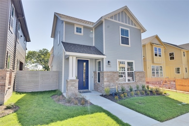 View of front of home featuring a shingled roof, fence, and a front lawn