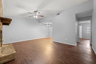 Unfurnished living room featuring a textured ceil