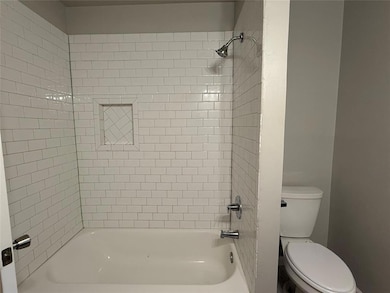 Bathroom featuring toilet and shower / tub combination