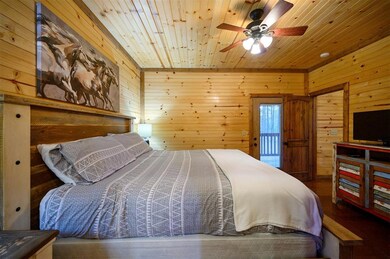 Bedroom featuring wooden walls and wooden ceiling