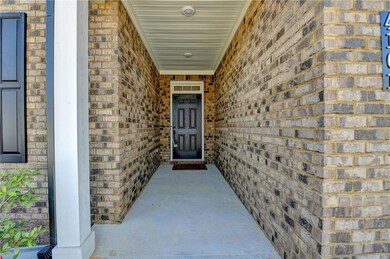 Doorway to property featuring brick siding