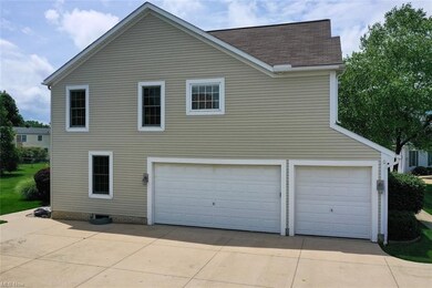 Three car garage with extra large concrete drivewa