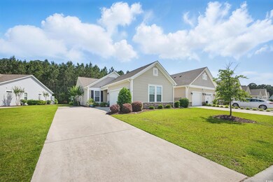 View of front of house featuring driveway, a garag
