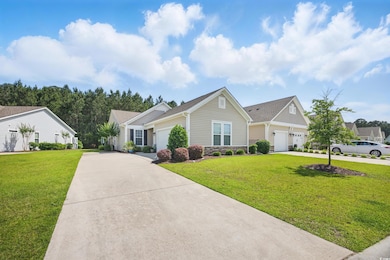 View of front of house featuring driveway, a garag