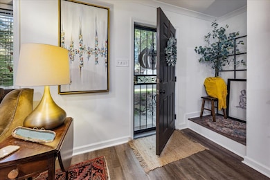 Foyer entrance with ornamental molding and dark ha