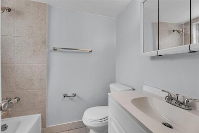 Full Bathroom with tub/ shower combo and white van