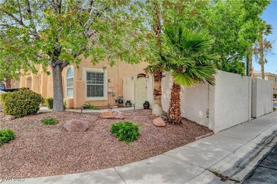 View of front of house with stucco siding and fenc
