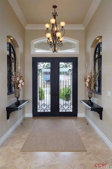 The foyer has a 14 ft ceiling, which gracefully ta