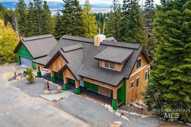 View of front of home with a shingled roof, a porch, board and batten siding, and a mountain view