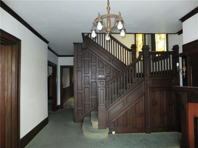 Enter into this grand foyer with incredible woodwo