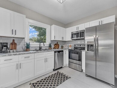 Kitchen featuring stainless steel appliances, whit