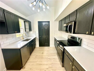 Kitchen w/quartz countertops & tile backsplash