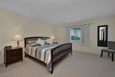 Bedroom featuring light colored carpet and baseboards