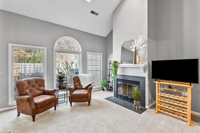 The spacious yet cozy living room has a gas fireplace. The Palladian window brings in natural light and adds a nice architectural detail.