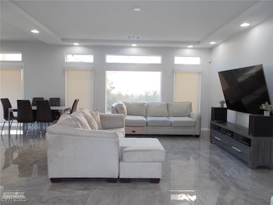 Living room with marble tiled flooring and recesse