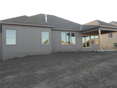 Back of home. Covered patio.  Level yard.