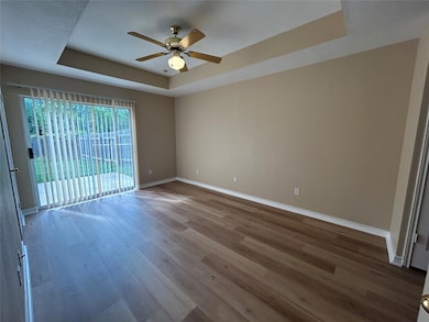 Unfurnished room featuring a tray ceiling, a ceil