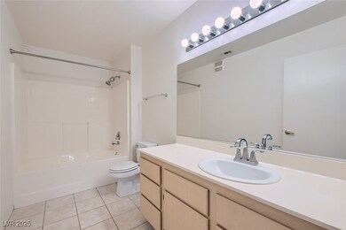 Full bathroom with light tile patterned flooring, shower / bath combination, and vanity