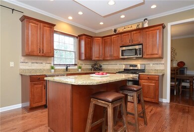 The kitchen includes hardwood floors, upgraded cab