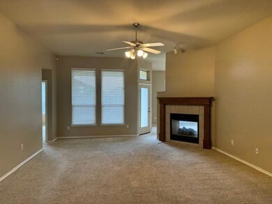 Unfurnished living room with ceiling fan, carpet floors, and a tile fireplace