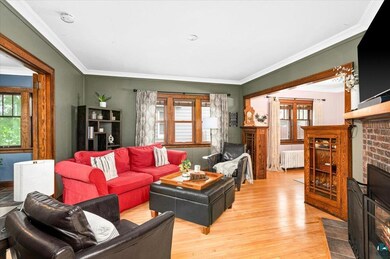 Living room with ornamental molding, a brick firep