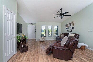 OPEN LIVING ROOM WITH NEW FLOORING.