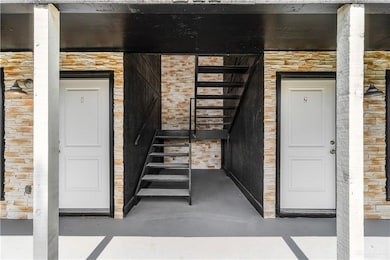 View of exterior entry featuring stone siding