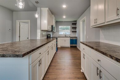 Kitchen with dark hardwood / wood-style flooring, 