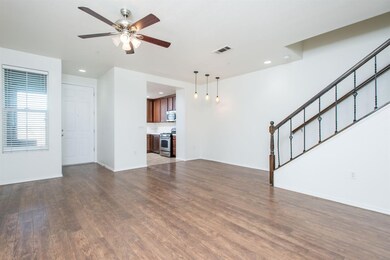 Living area looking into entry and kitchen