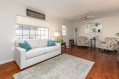 Living room with ornamental molding, ceiling fan, 