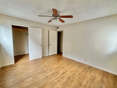 Unfurnished bedroom with wood finished floors, ba