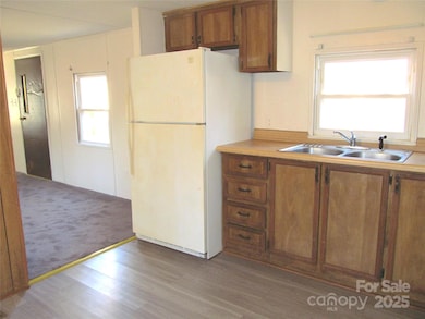 Kitchen with Refrigerator with view into living room